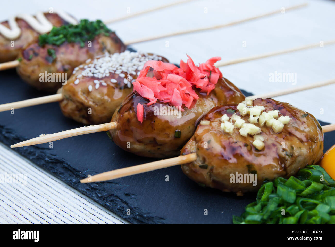 Tsukune Japanese chicken yakitori meatballs served with chili sauce