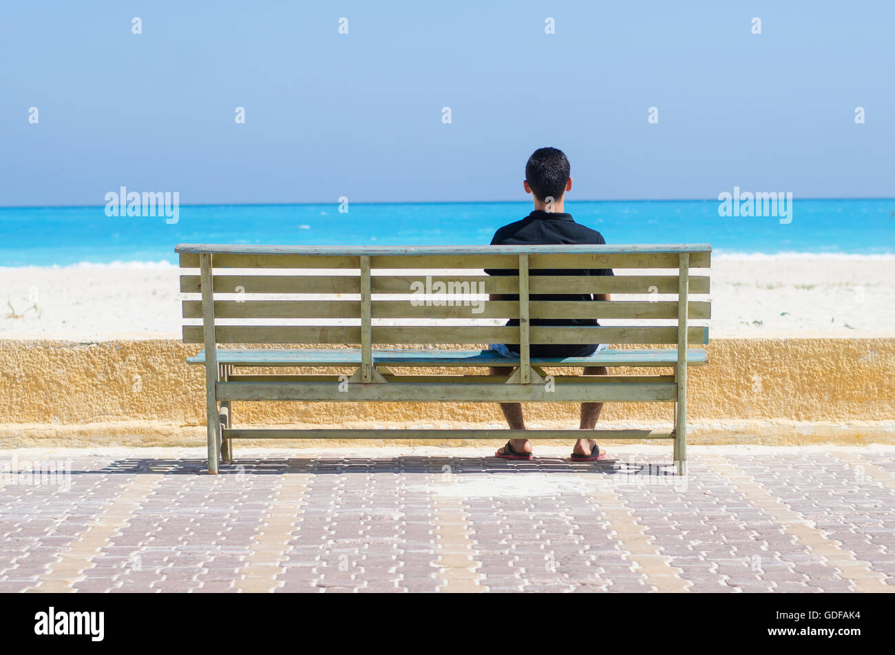 lonely man sitting on a chair at the sea Stock Photo - Alamy