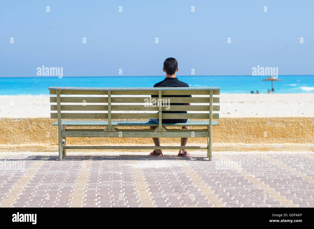 lonely man sitting on a chair at the sea Stock Photo - Alamy