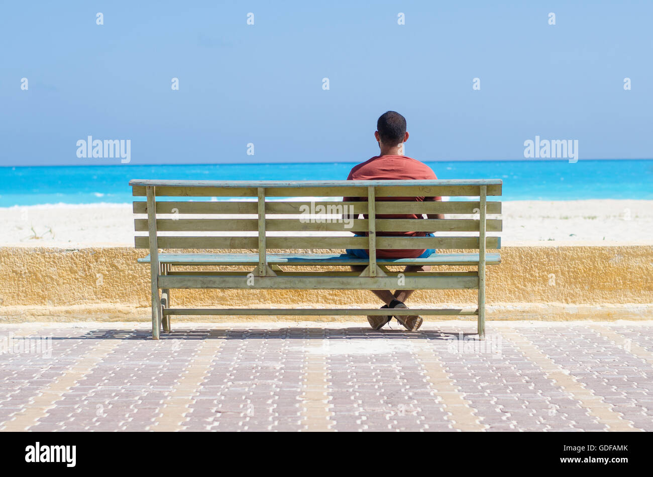lonely man sitting on a chair at the sea Stock Photo - Alamy