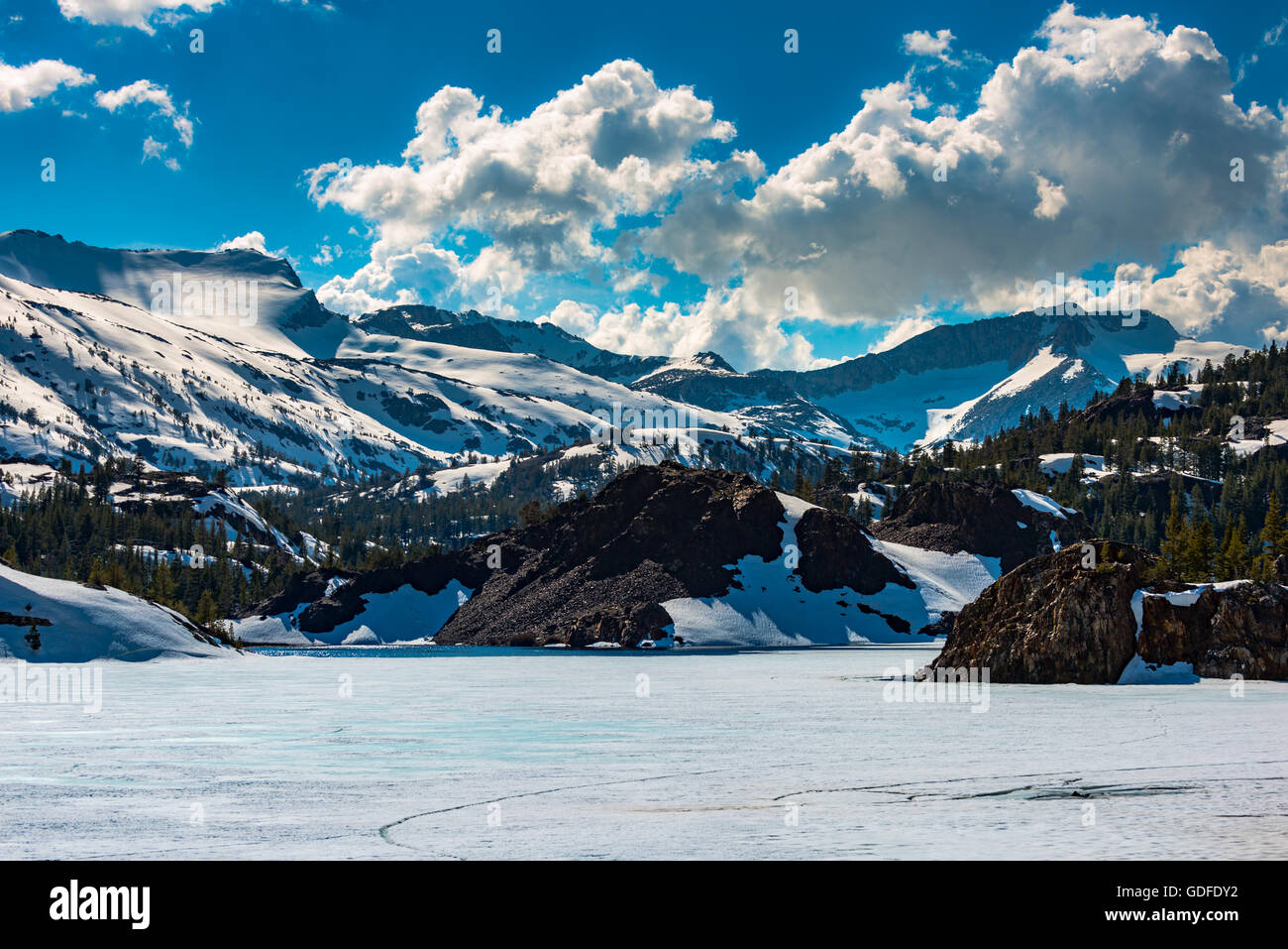 Sunny Winter Day Malting Snow Ellery Lake near Tioga Pass Yosemite California USA Stock Photo