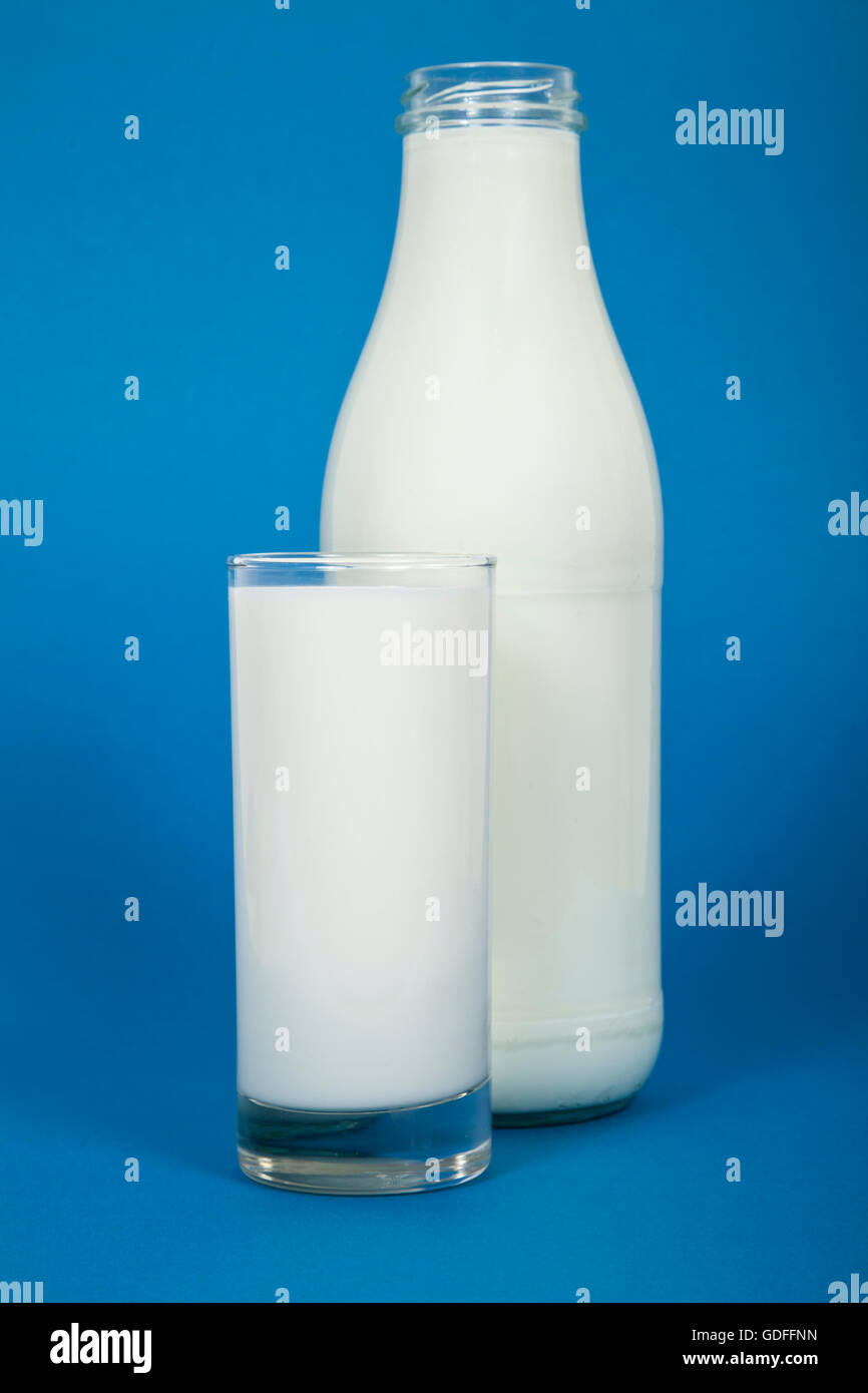Glass and bottle of milk on blue background Stock Photo