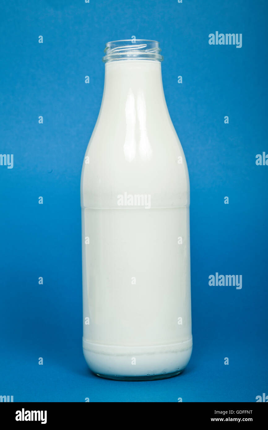 Bottle of milk on blue background Stock Photo