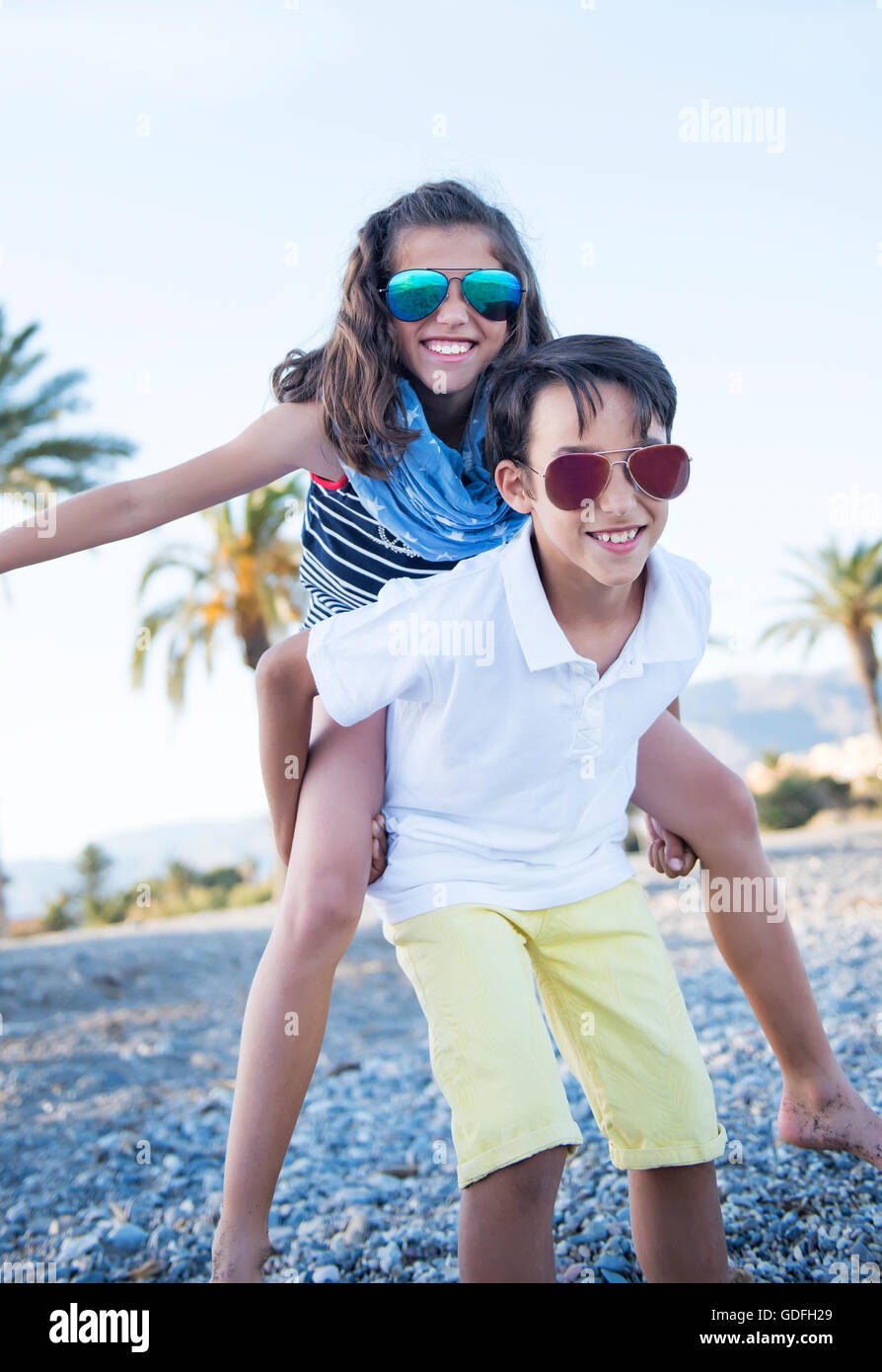 Cheerful cute boy and girl playing outdoors Stock Photo