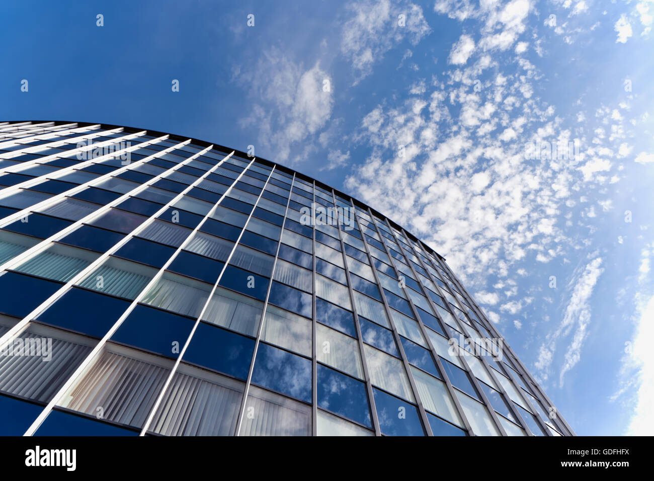 Sky reflecting in glass facade of an office building Stock Photo