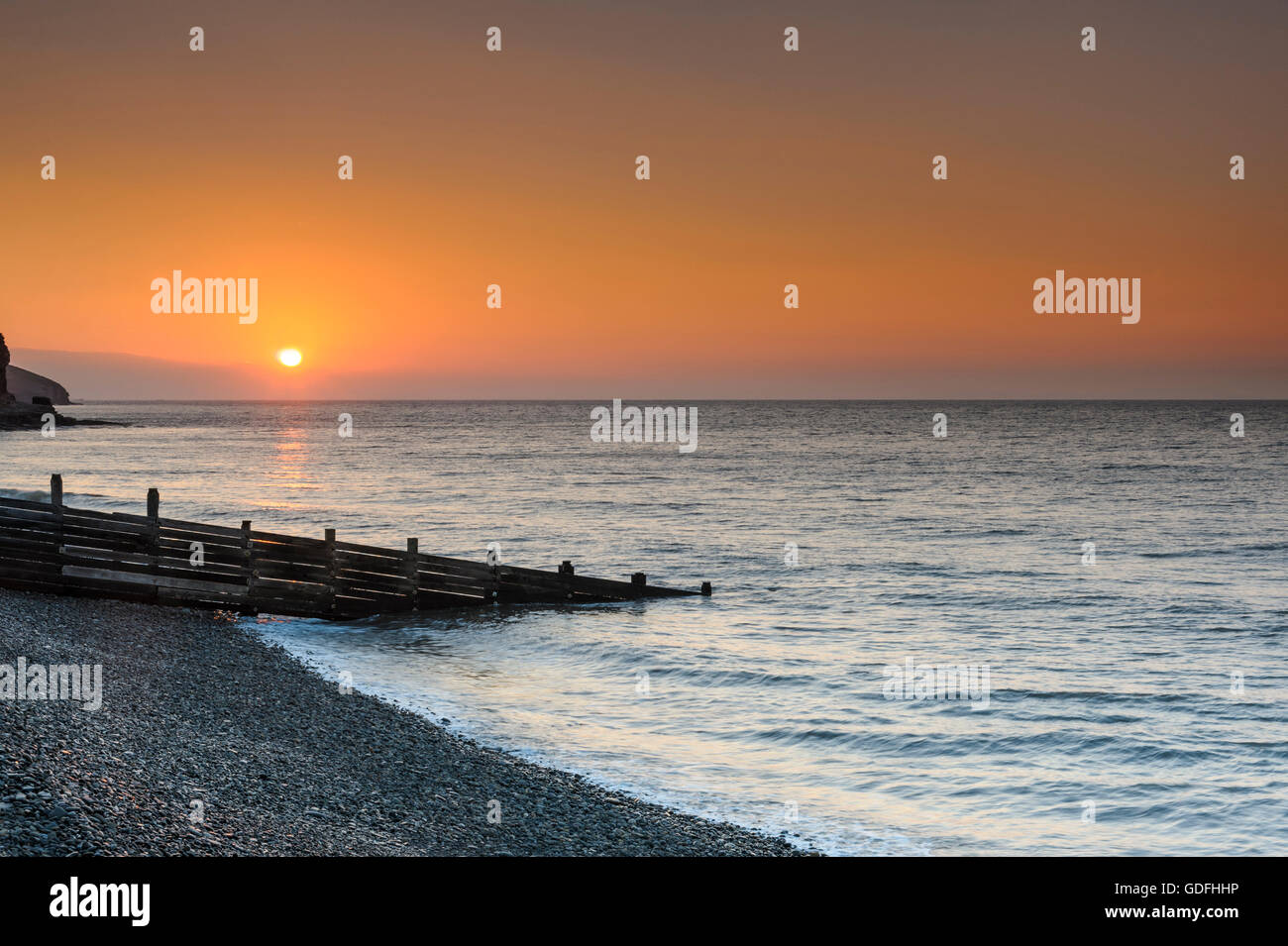 Sunrise on a Welsh beach. Stock Photo