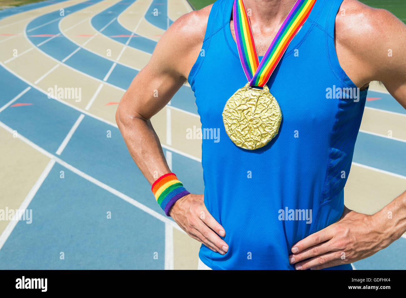 Gay athlete standing with gold medal and rainbow ribbons at a blue and