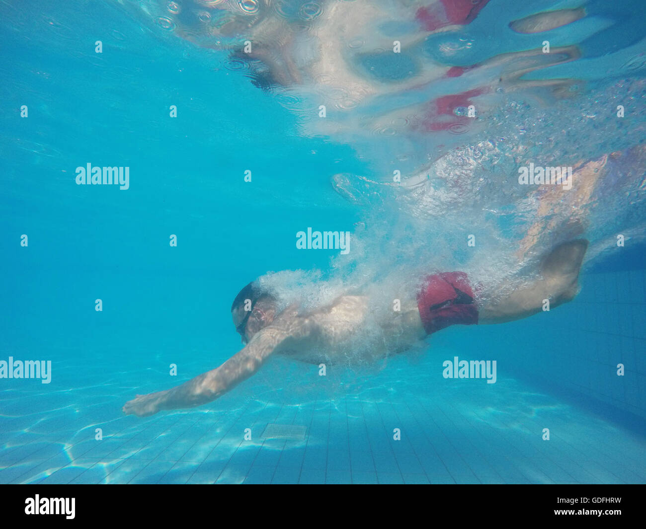 Man diving into swimming pool hi-res stock photography and images - Alamy