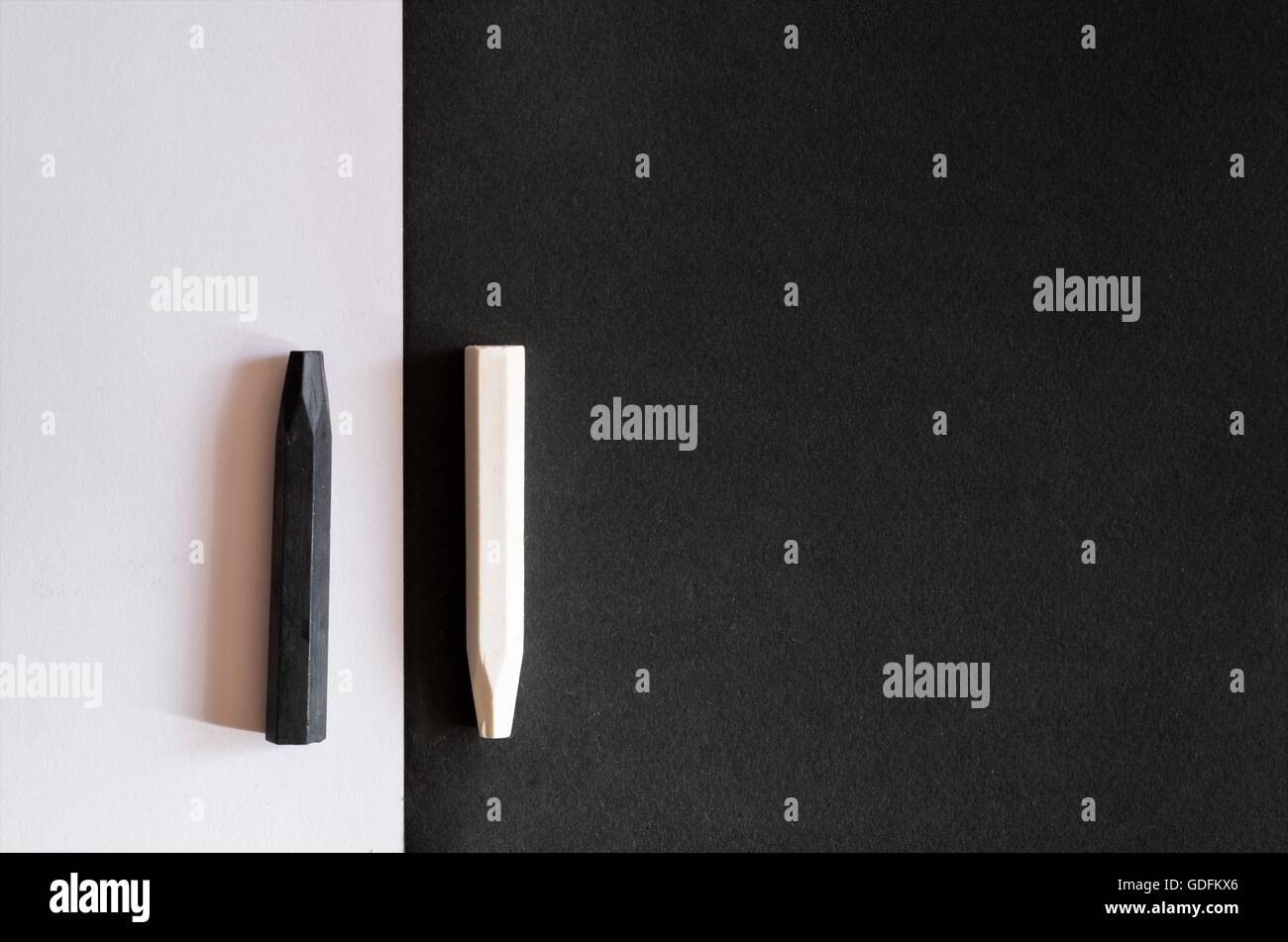 black and white crayons on alternate background of the same color, to symbolize the differences