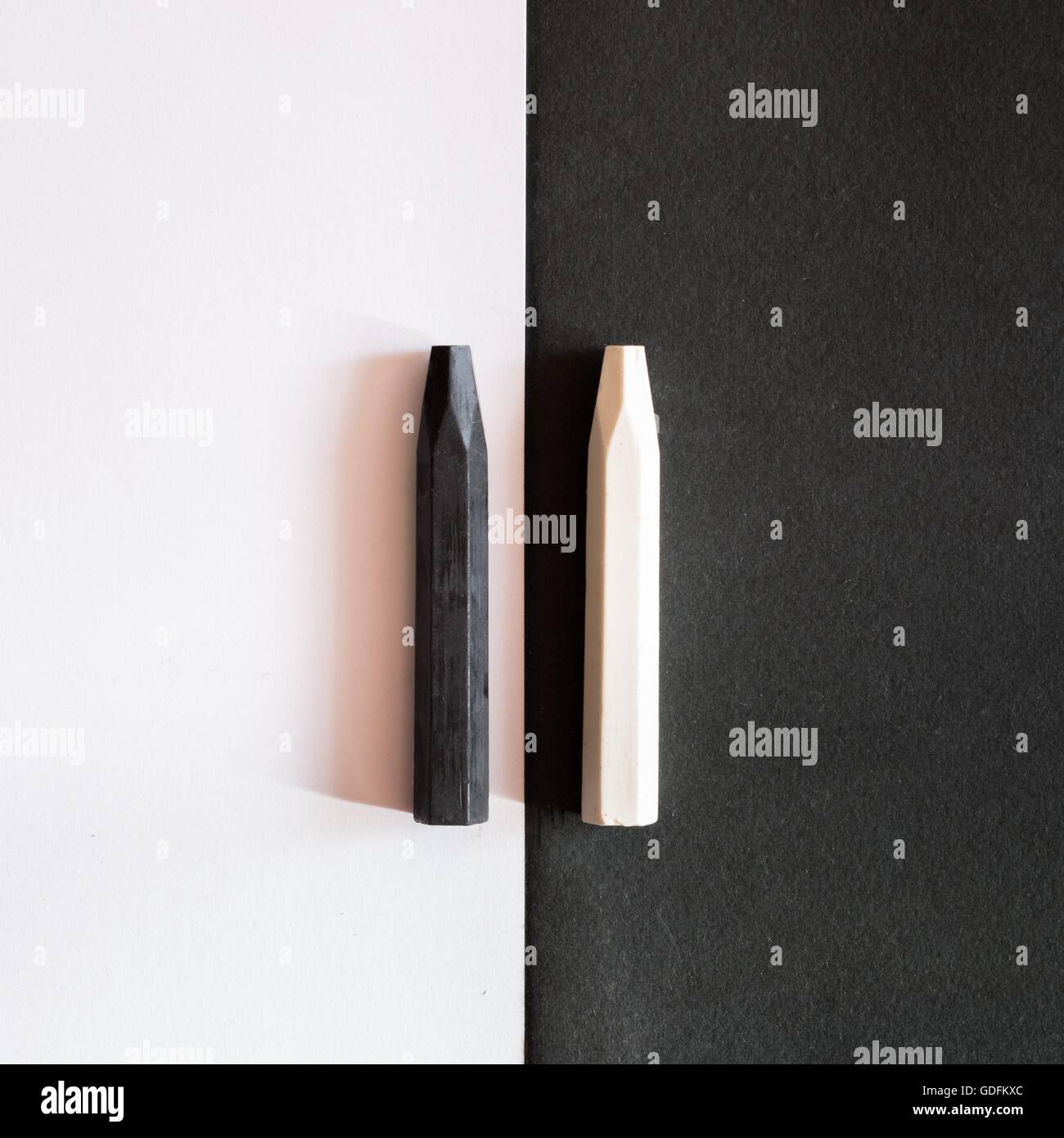 black and white crayons on alternate background of the same color, to symbolize the differences