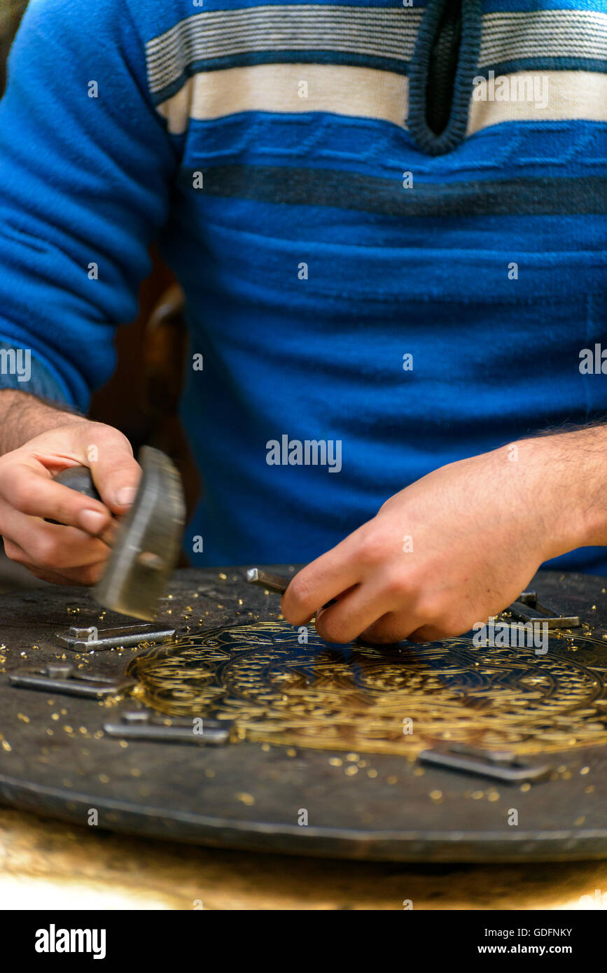 Two Hands of Craftsman Engraving Decorative Brass Masterpiece Stock