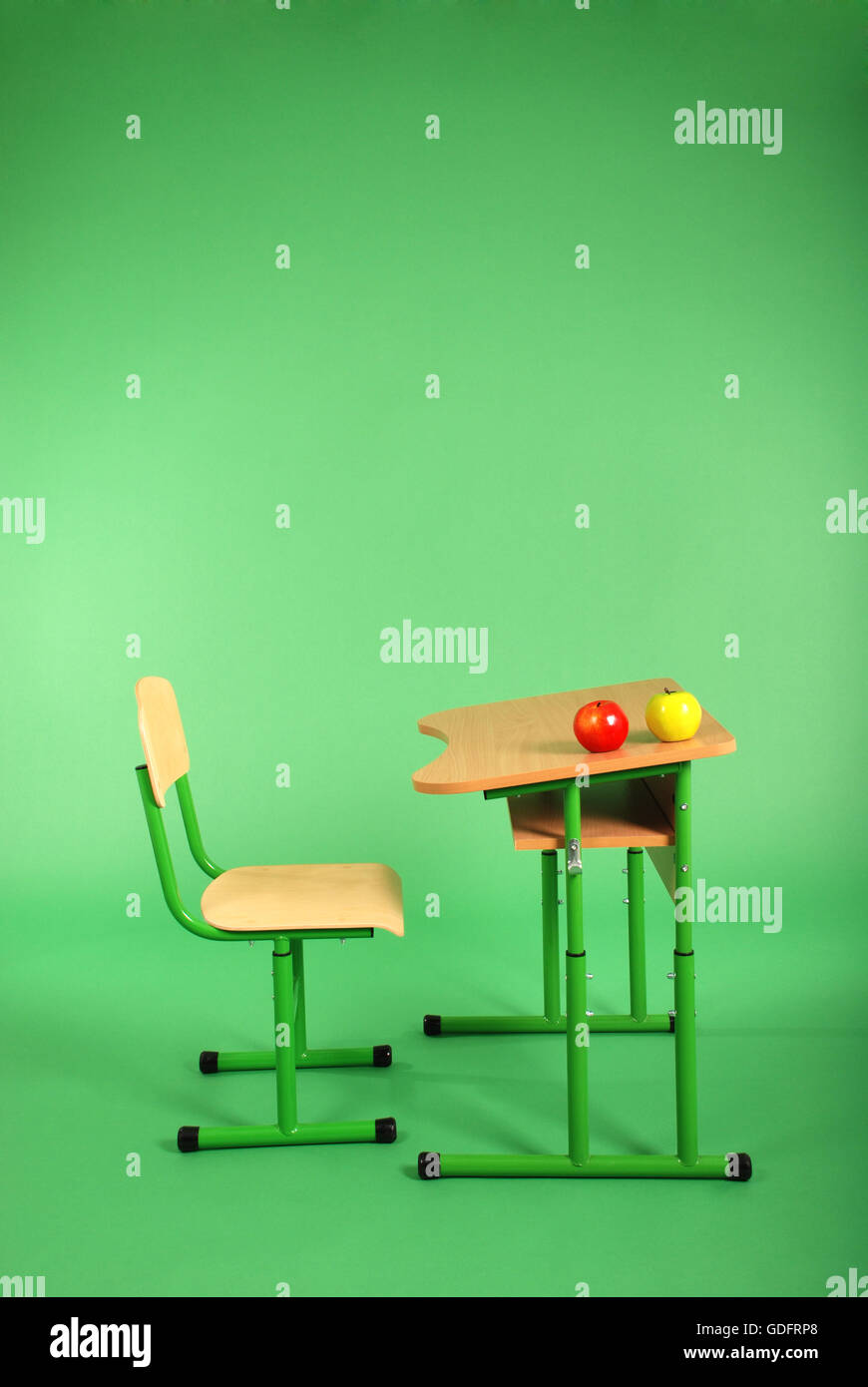 New school desk and chair on green background Stock Photo