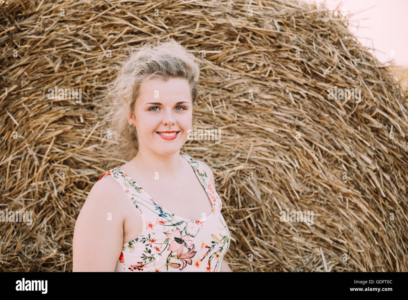 Beautiful Plus Size Young Woman In Shirt Posing In Summer Field Meadow Near Hay Bale Stock Photo