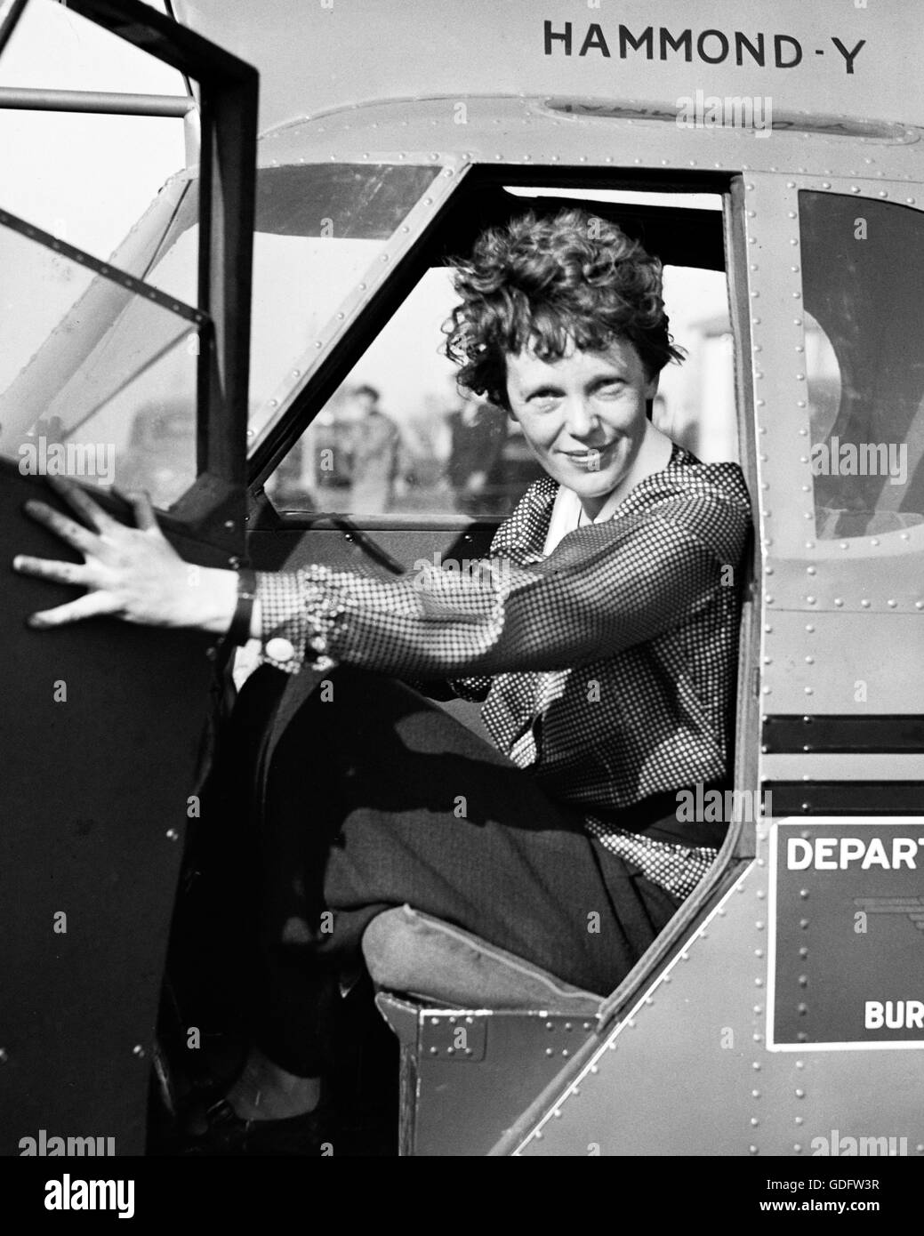 Amelia Earhart (1897-1937) in the cockpit of an airplane c.1936. Photo by Harris and Ewing,. Stock Photo