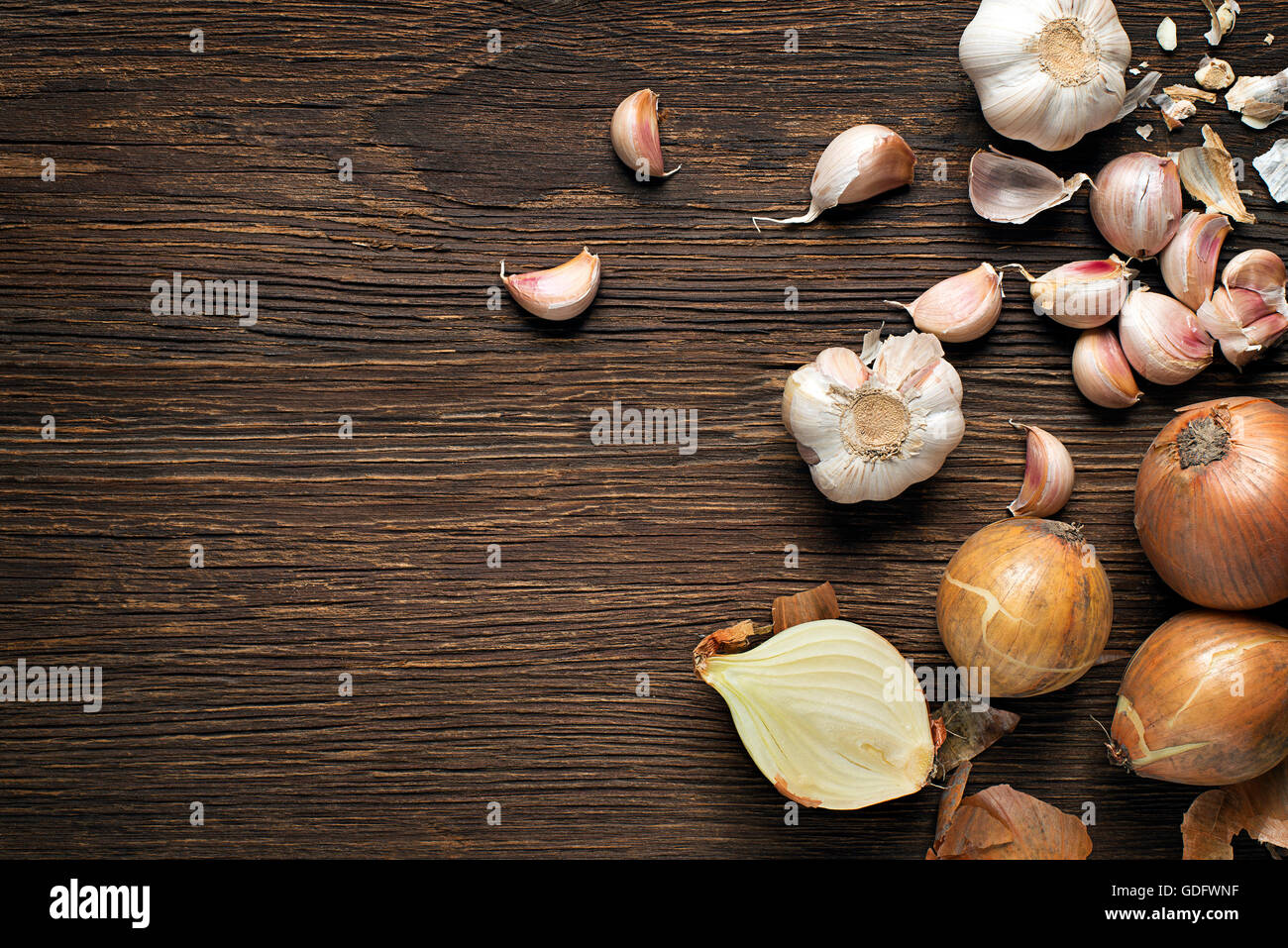 Garlic cloves and onions on wooden vintage background Stock Photo - Alamy