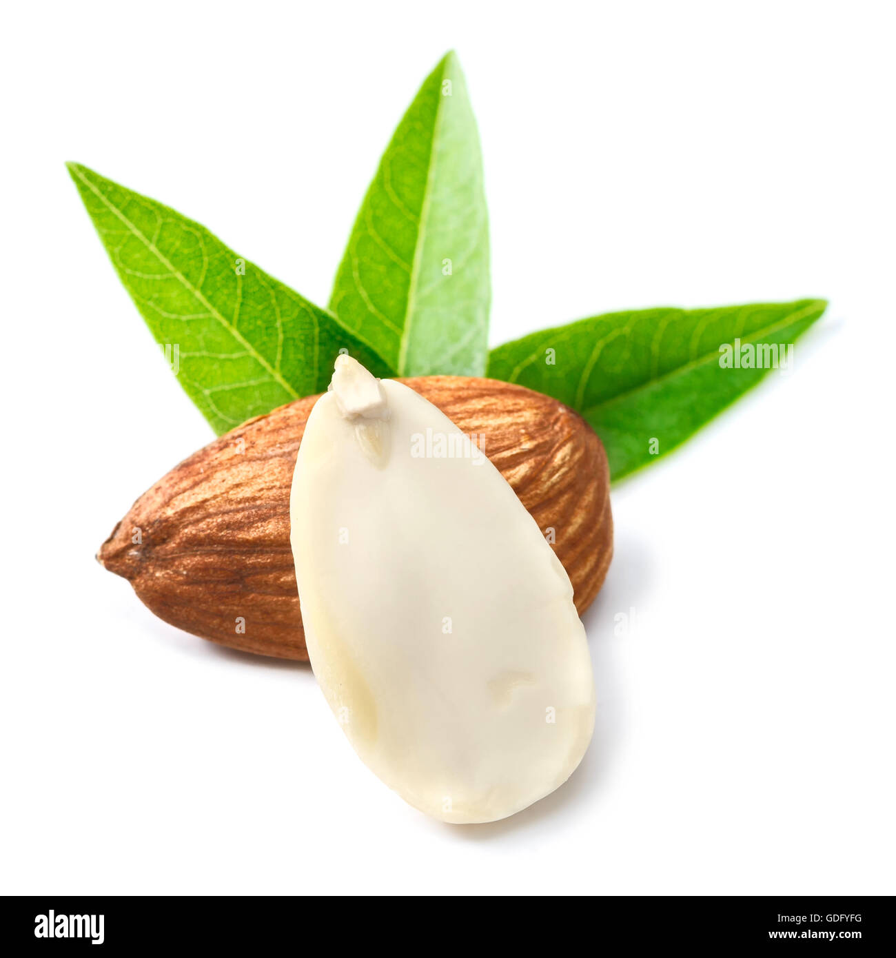 dried almond nuts and fresh leaves on white Stock Photo