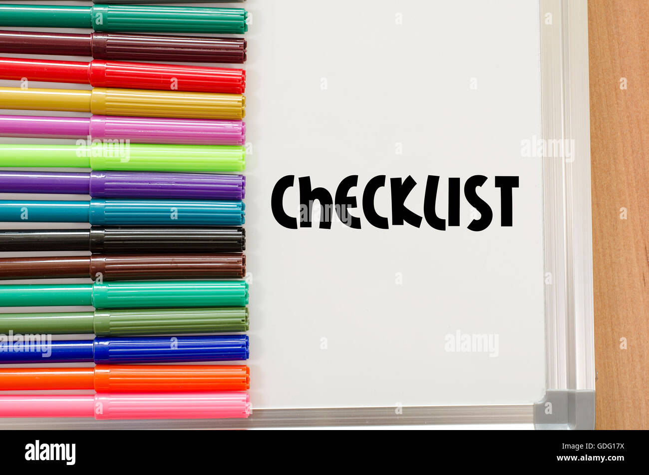 Checklist written on whiteboard over wooden background Stock Photo Alamy