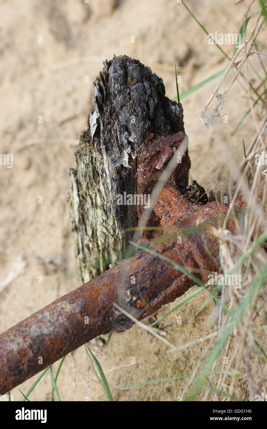 A weathered post and rail on the beach Stock Photo