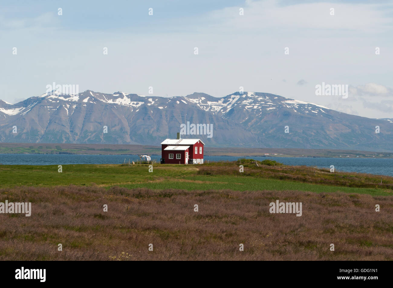 Iceland a red wooden house in Icelandic countryside. Colorful wooden houses are one of the main