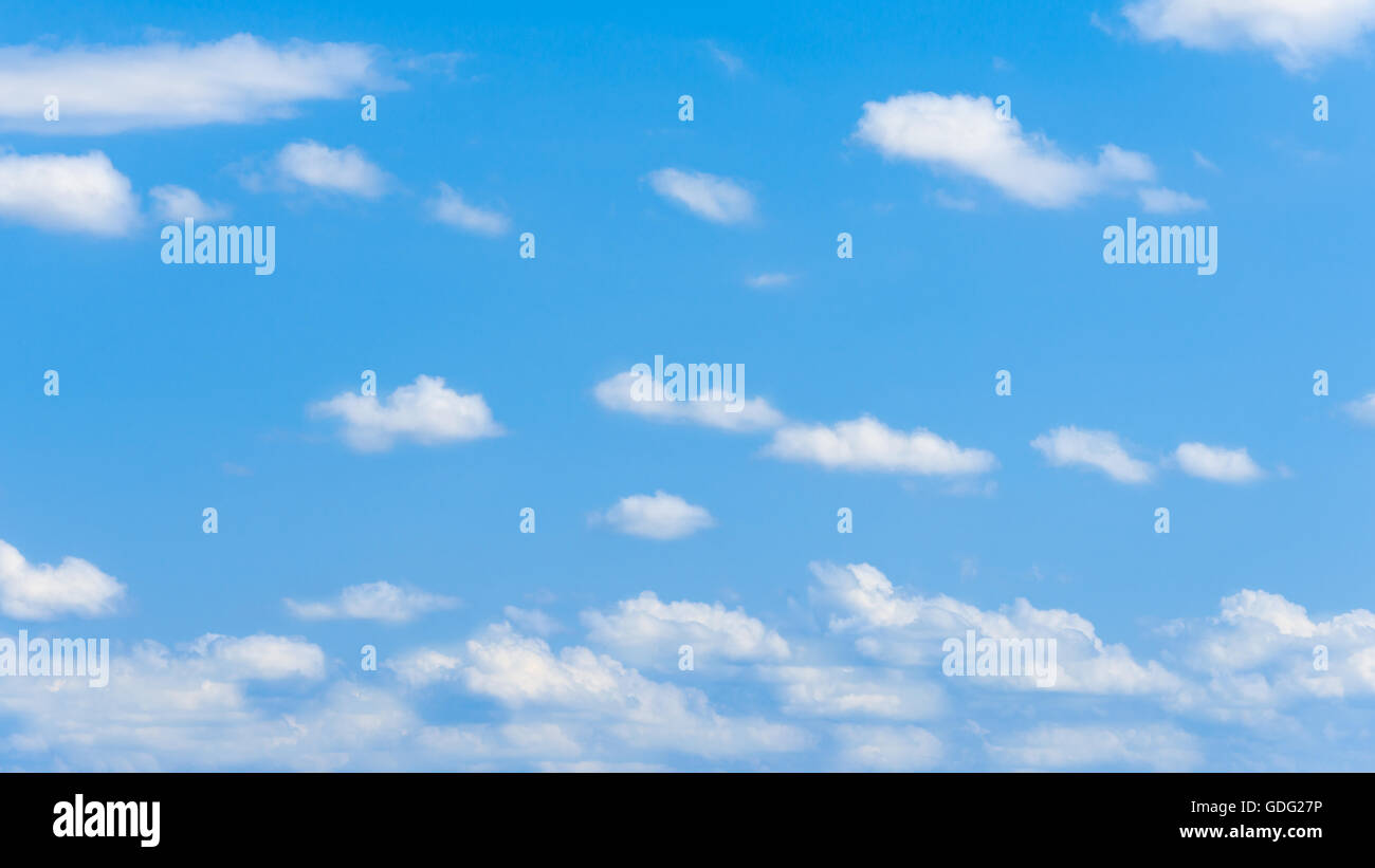 Clear blue sky with white fluffy clouds Stock Photo