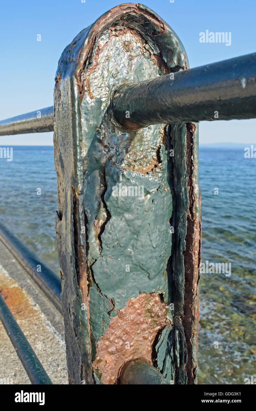 Corroded metal fence on the sea promenade. Stock Photo