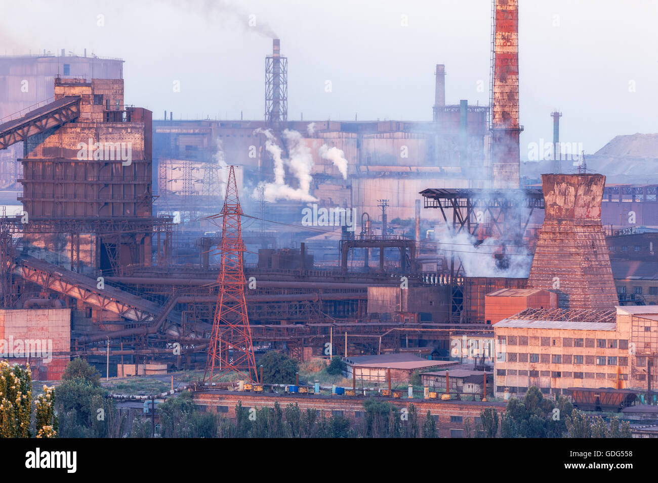 Industrial landscape in Ukraine. Steel factory at sunset. Pipes with smoke. Metallurgical plant. steelworks, iron works. Heavy i Stock Photo