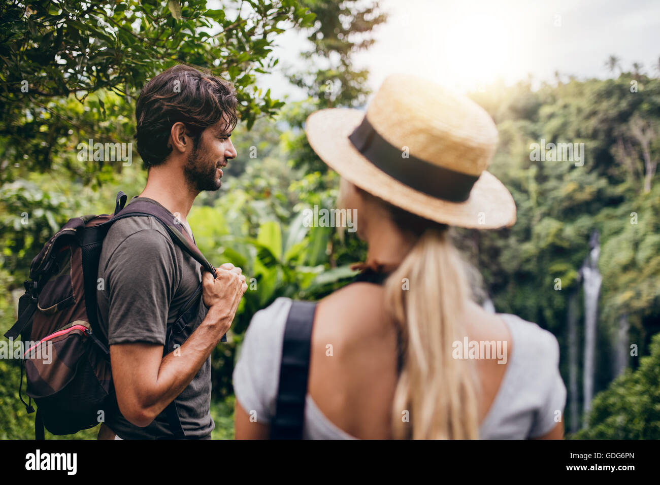 Outdoor shot of young man standing with his girlfriend in forest. Couple on holiday in nature. Stock Photo