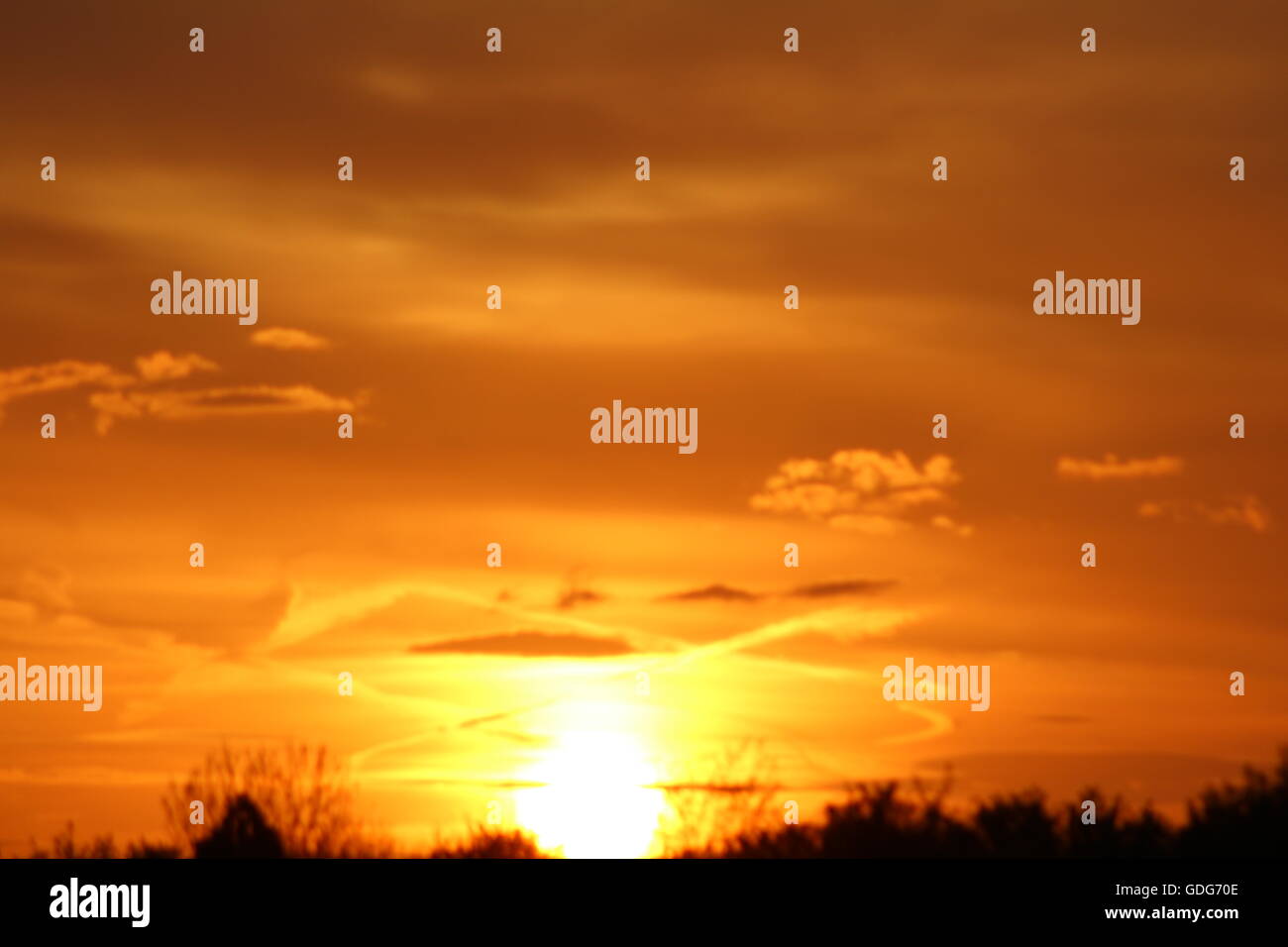 An orange sunset over fields Stock Photo - Alamy