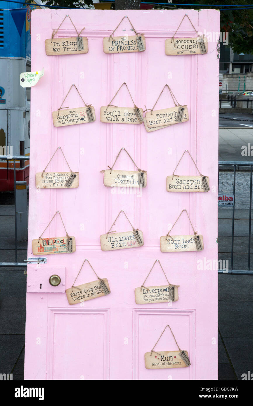 Stall selling comedy hanging door signs at Pier Head in Liverpool Merseyside, UK Stock Photo