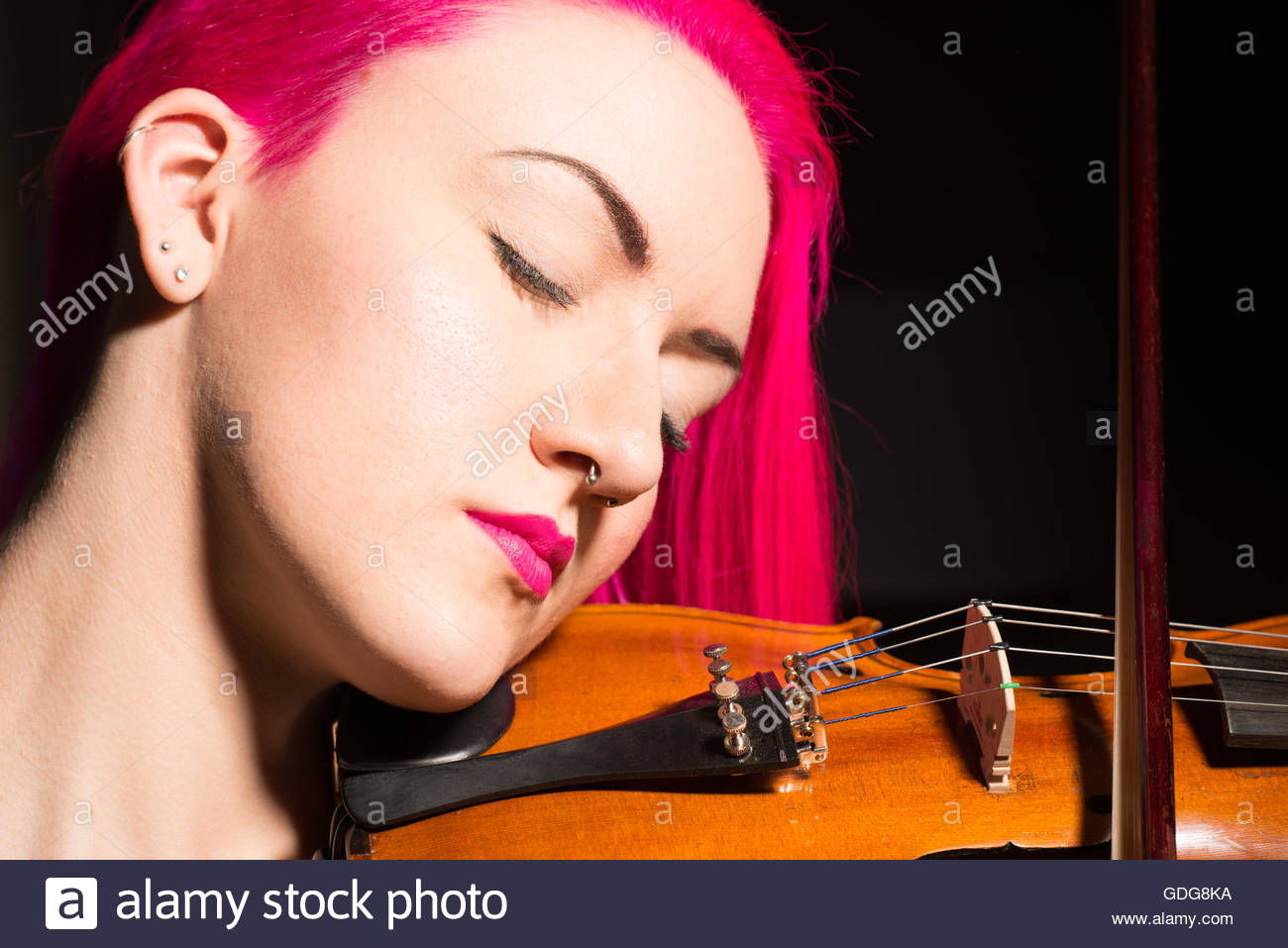 Young Woman With Bright Red Hair Playing A Violin On A Black