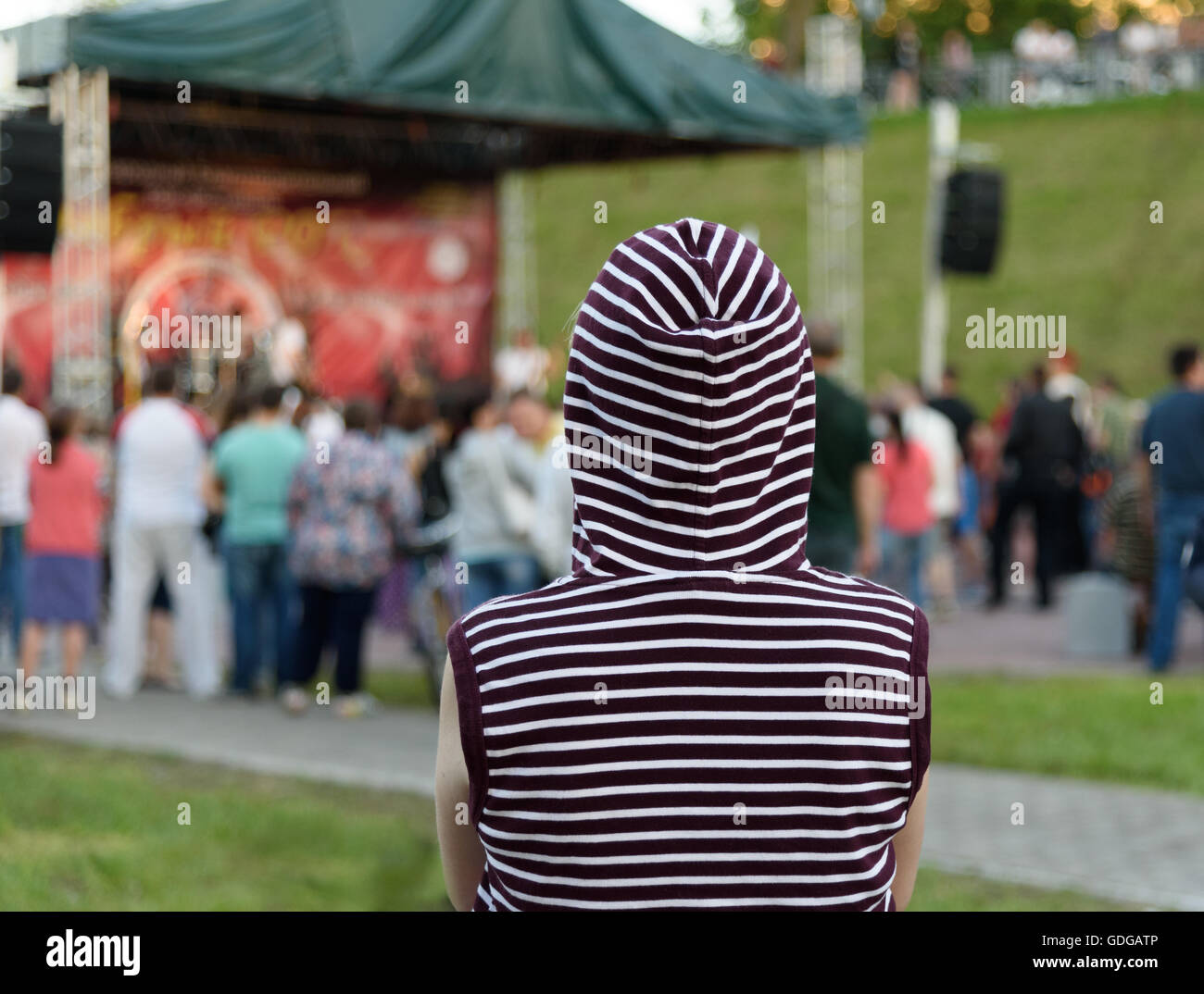 lonely girl is back in the hood at a street rock concert Stock Photo