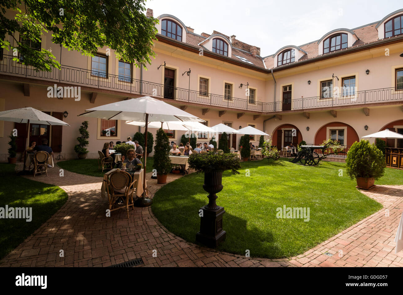 An inner courtyard of a hotel where guests may have either refreshments or lunch at a hotel/restaurant on Buda Castle Hill, Budapest, Hungary. Stock Photo