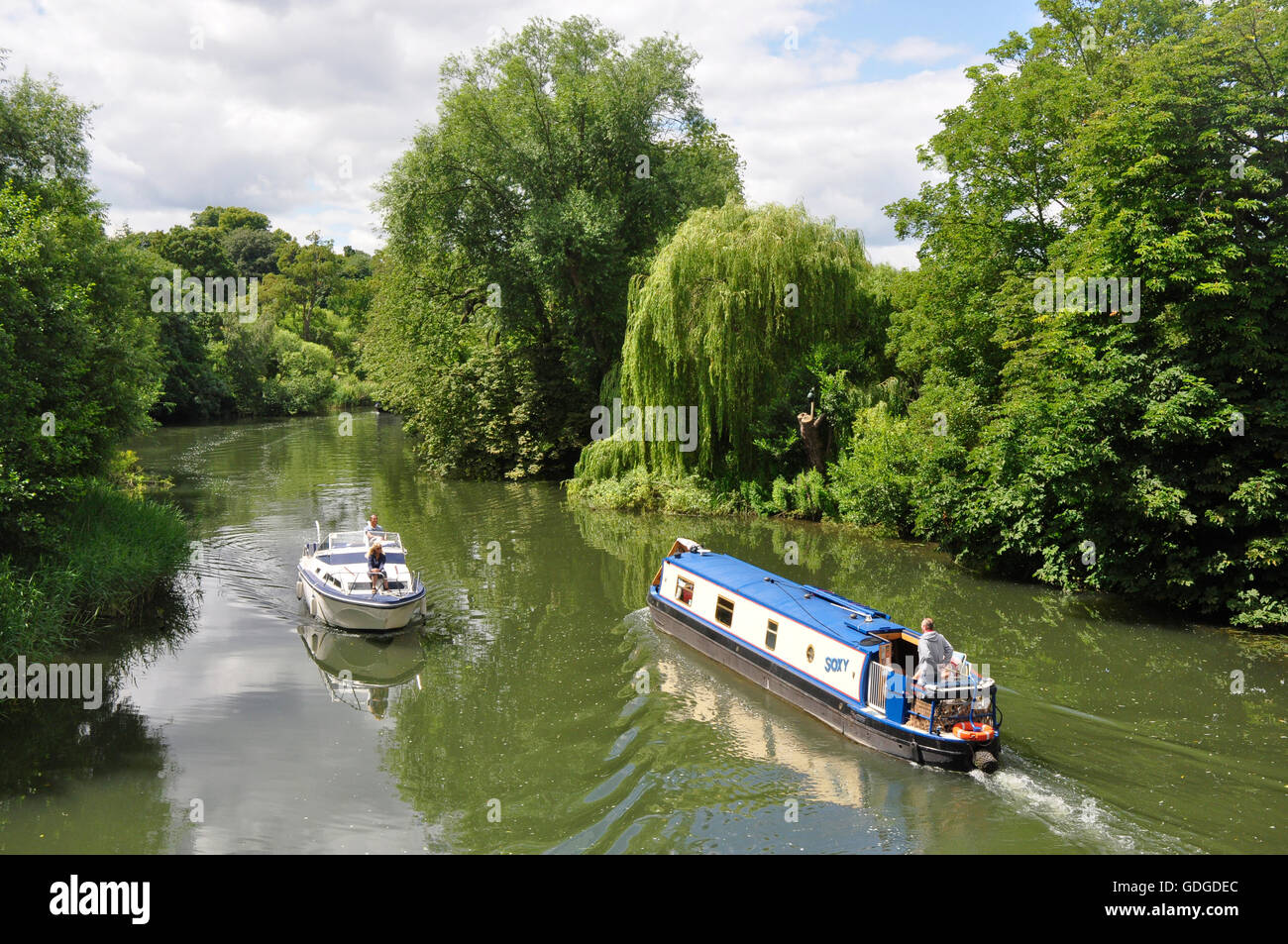 Berkshire -at Sonning on Thames - bridge view - pleasure boats passing - reflections in the water - wooded banks - summer sun Stock Photo