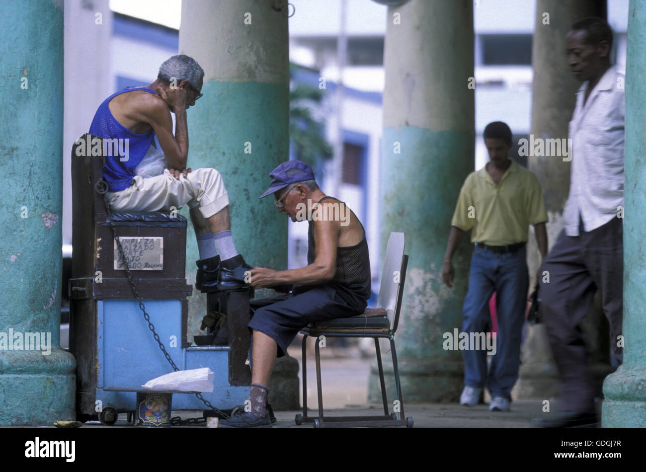 a shoe cleaner in the city of las Tunas on Cuba in the caribbean sea. Stock Photo
