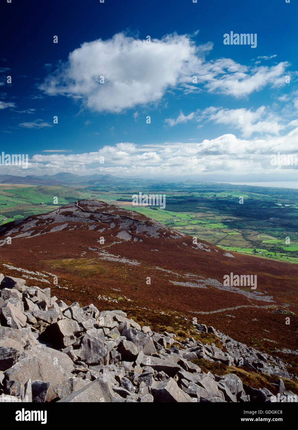 Wide view E from summit of Yr Eifl over Tre'r Ceiri hillfort (Town of the Giants) & NE part of Lleyn Peninsula to Snowdon Range. Stock Photo
