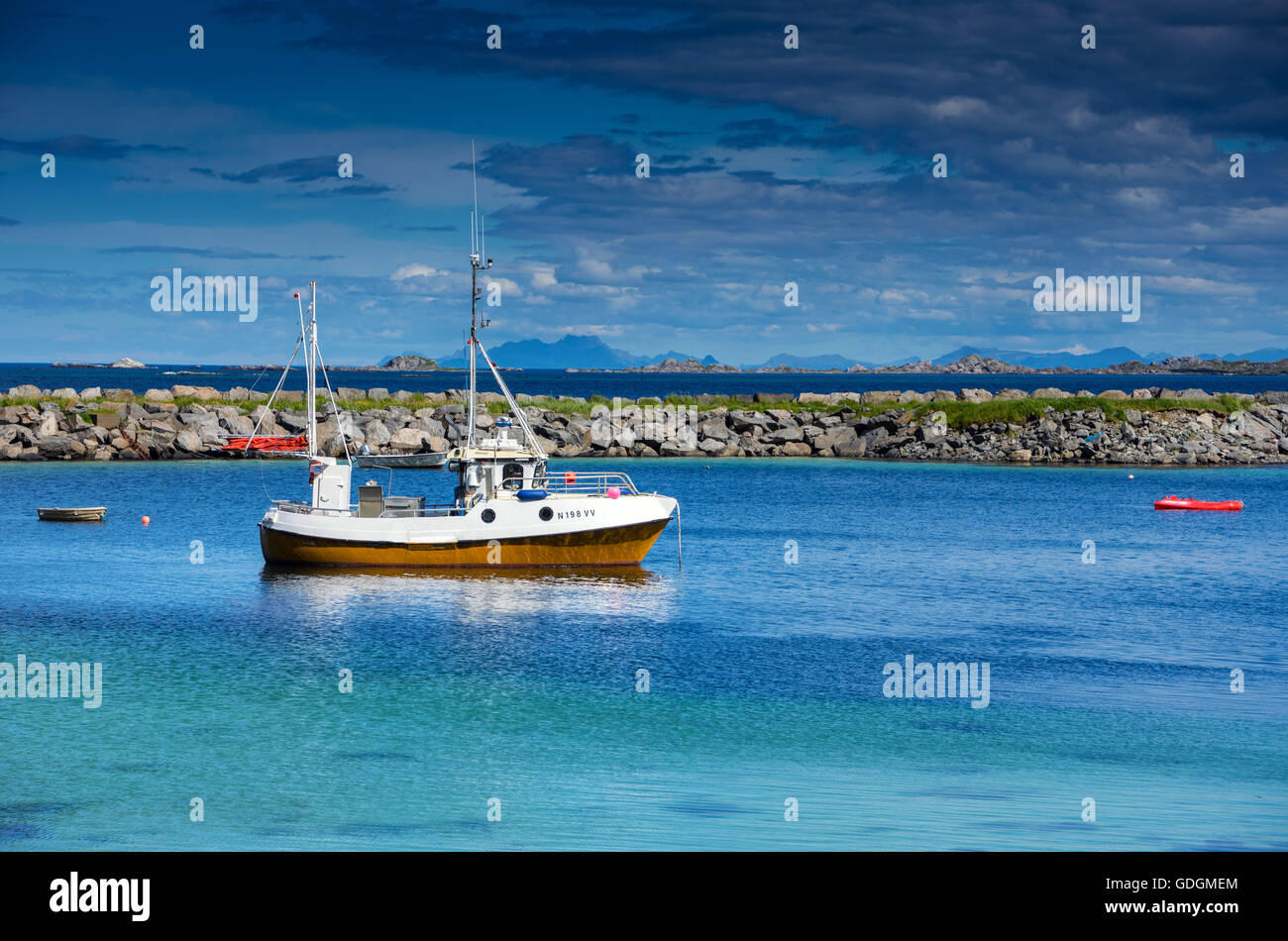 Small fishing boat anchored in calm Norwegian harbour Stock Photo - Alamy