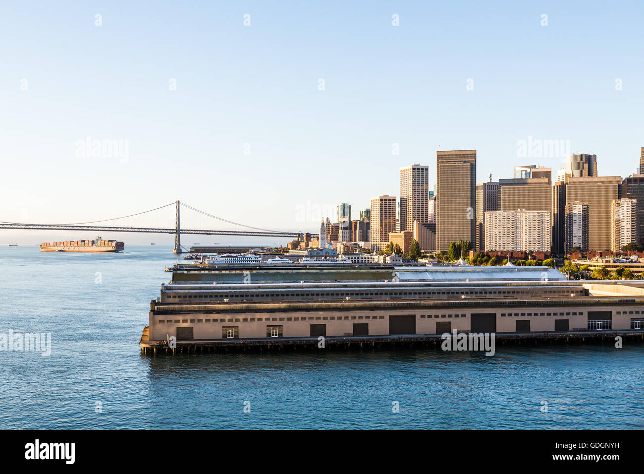 View of the coast of San Fransisco with piers, Bay Bridge and skyscrapers Stock Photo