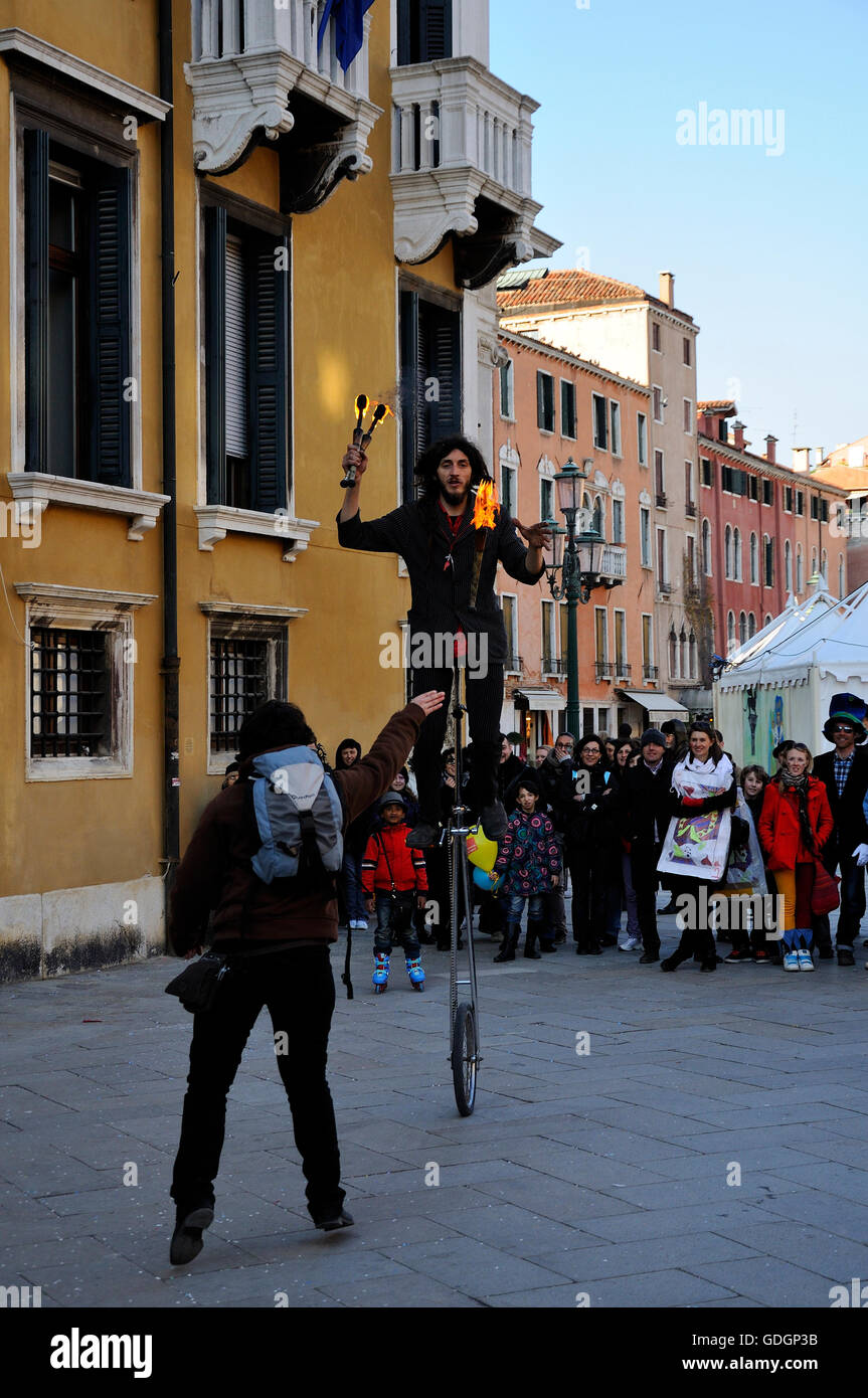 Juggler with torches in the street of Venice during Carnival of Venice