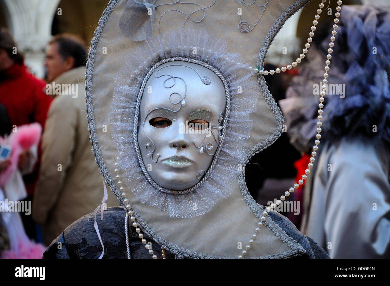 Man wearing moon shaped mask at Carnival of Venice. Stock Photo