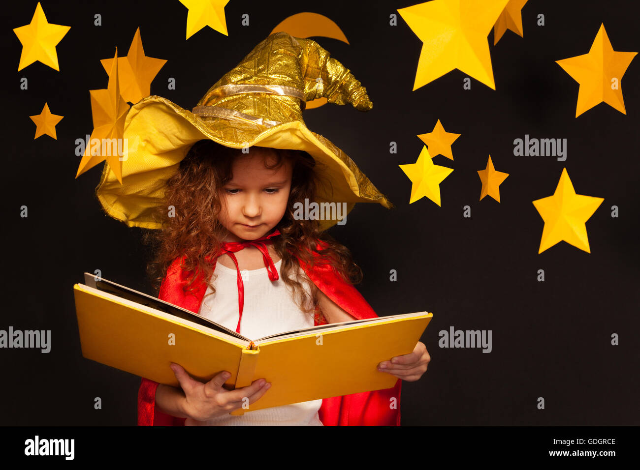 Little girl in sky watcher costume reading book Stock Photo - Alamy