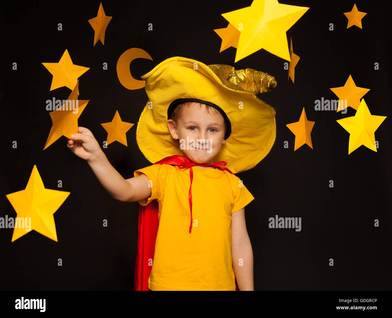 Little boy in stargazer costume among paper stars Stock Photo Alamy