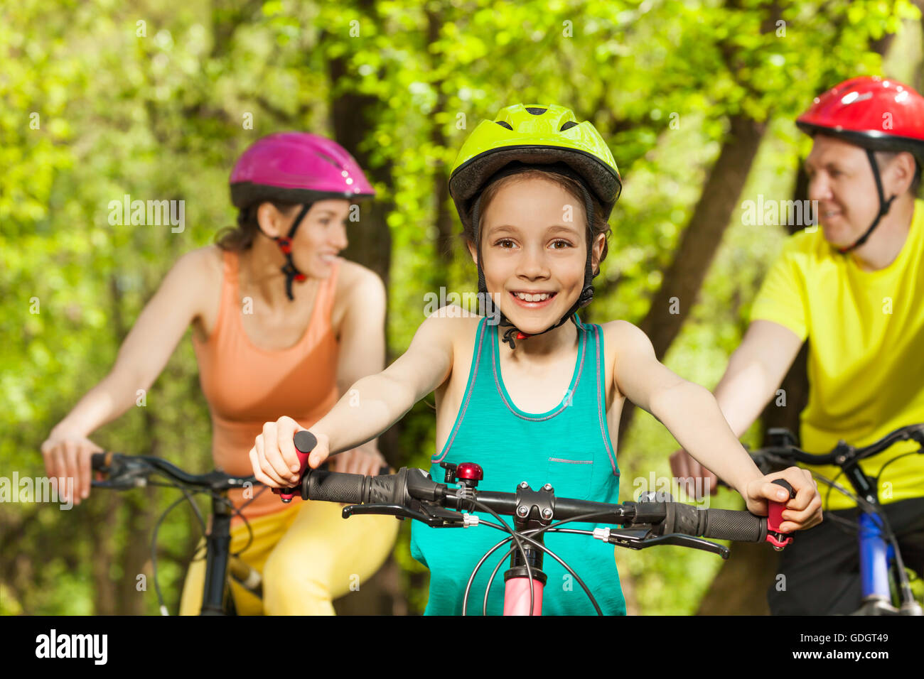 Teenage girl with parents during bike riding Stock Photo