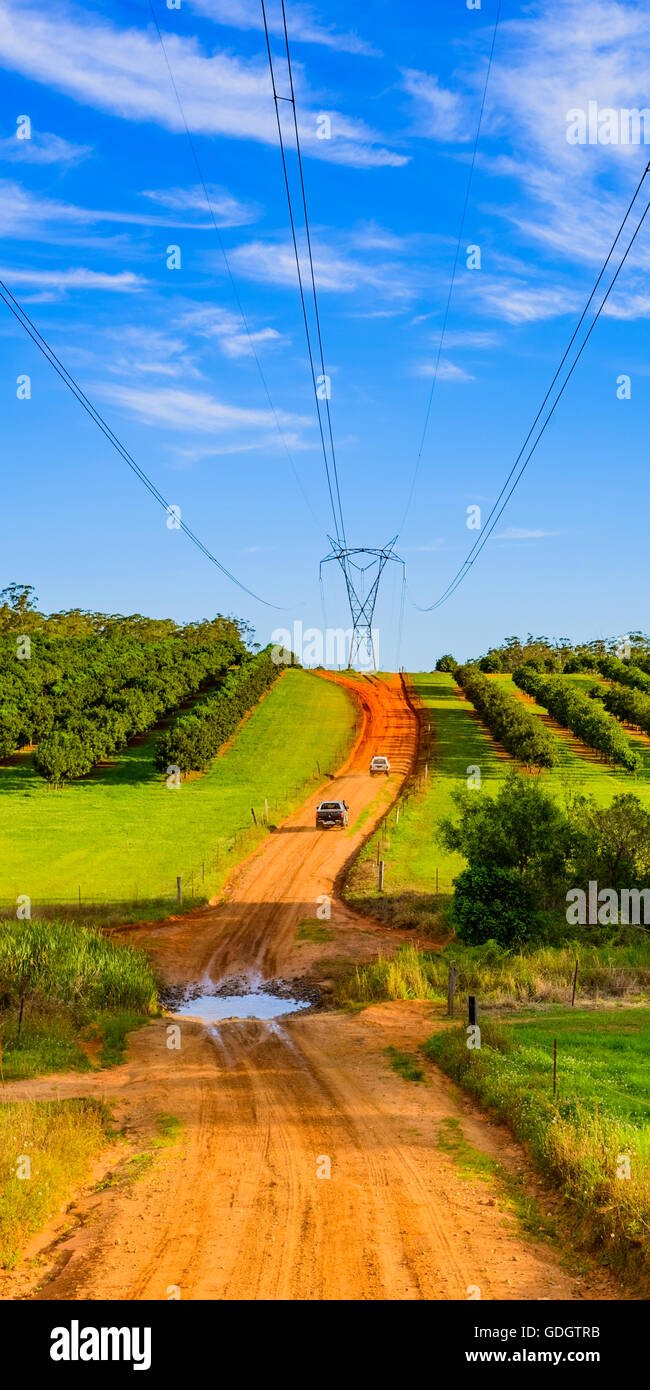 Four wheel drives (4WD) heading up a dirt track under a Powerlink