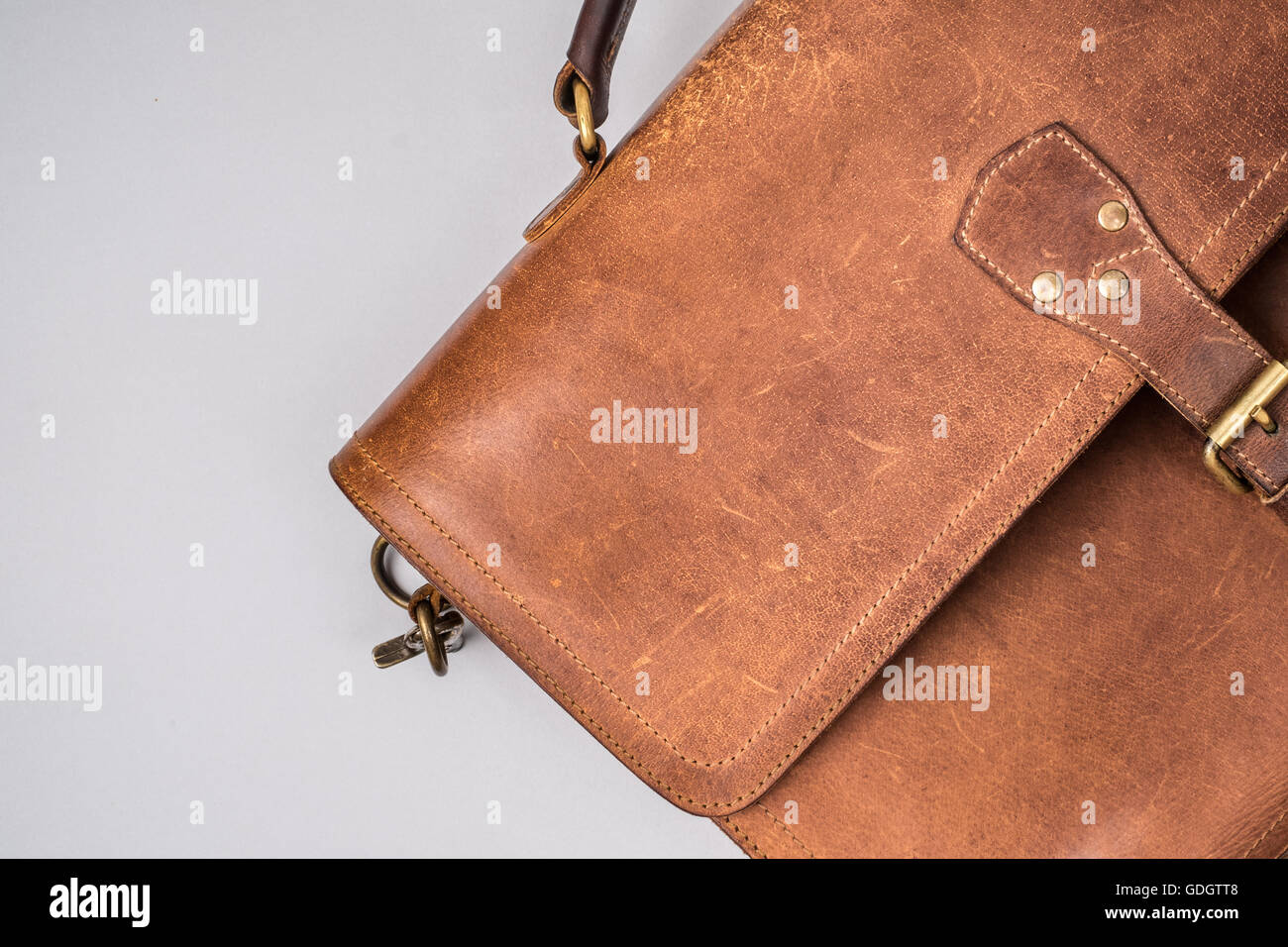 Brown Vintage leather briefcase with strap and brass buckle Stock Photo