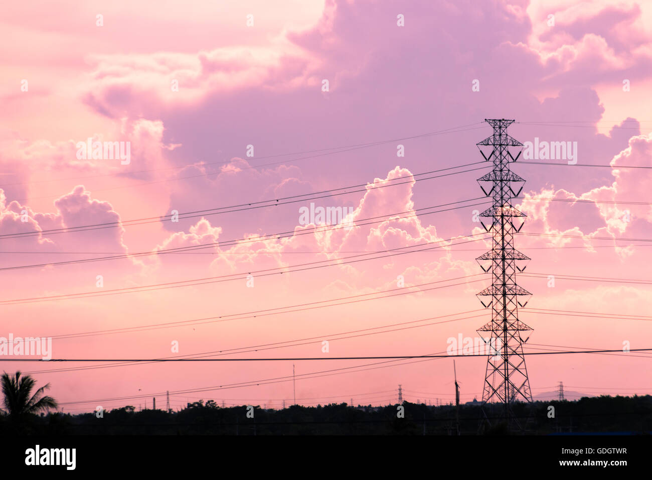 High voltage electric tower in the pink sky and cloud background Stock Photo