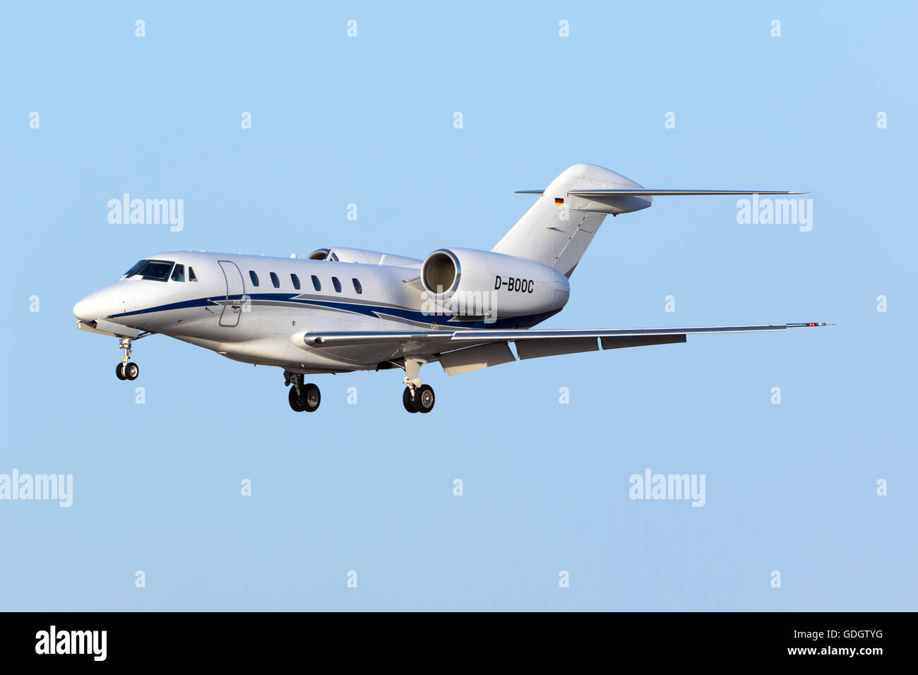 Air X Cessna 750 Citation X [D-BOOC] perfoming touch and go's on runway 31 in the evening. Stock Photo