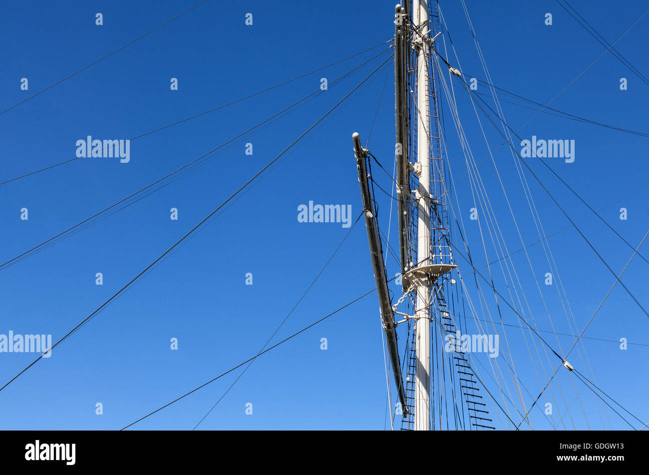 The masts and rigging on a full-rigged ship. Blue sky. Stock Photo