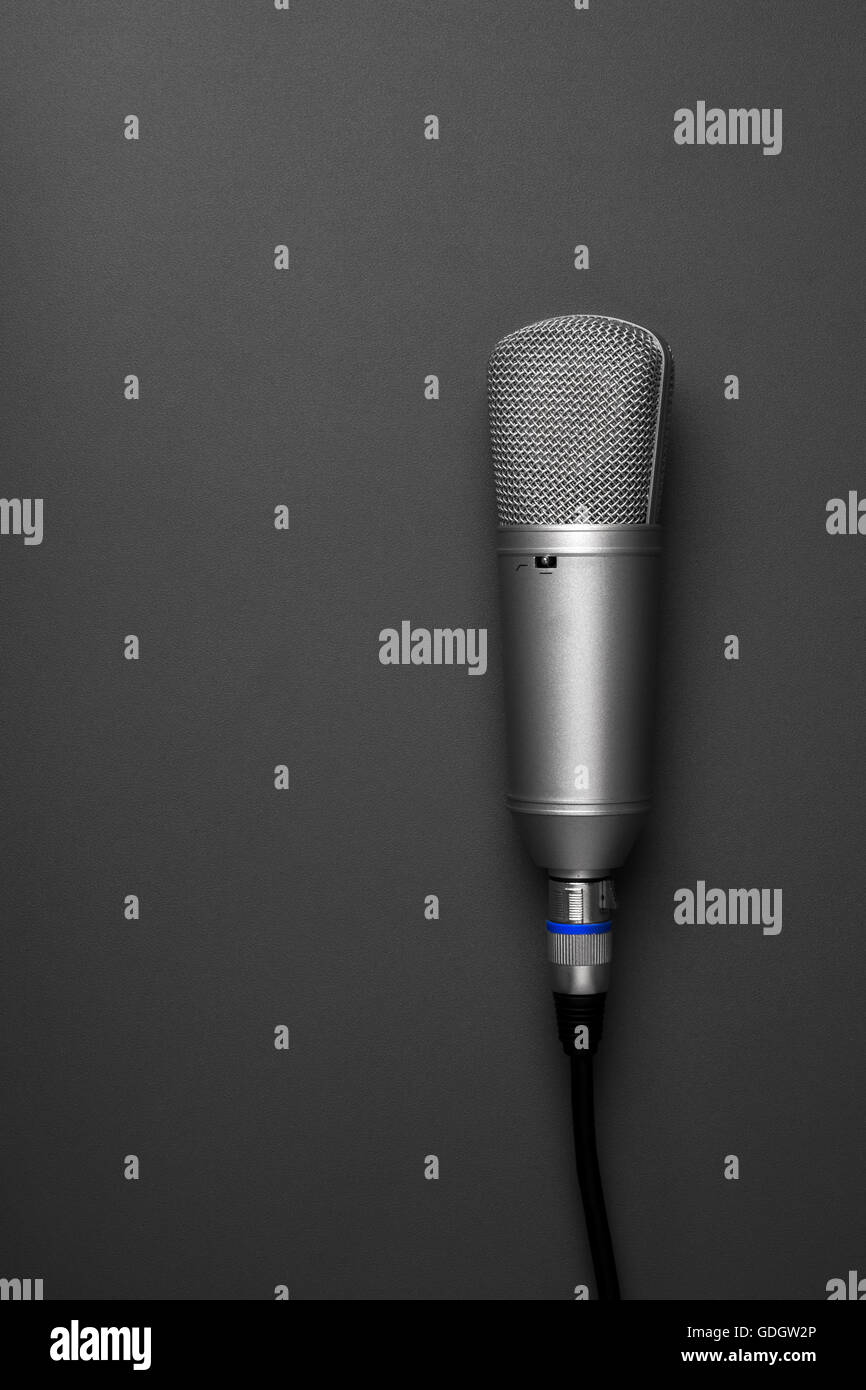 An isolated studio microphone on a grey background Stock Photo Alamy