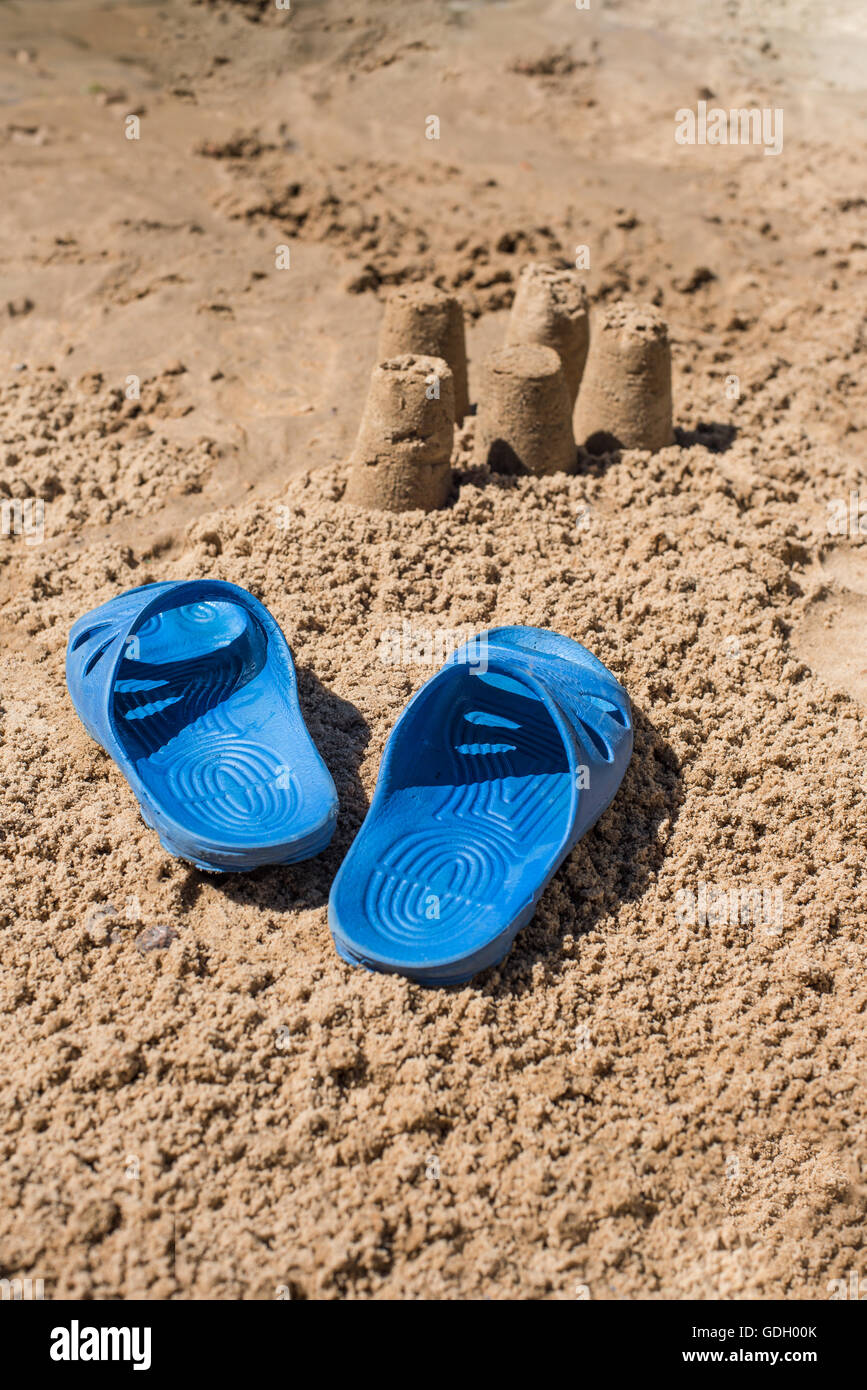 Flip-flops in the sand on the beach Stock Photo