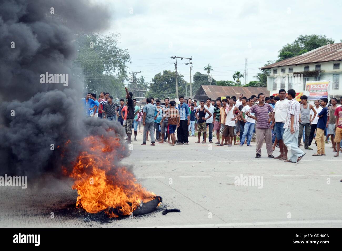 Assam, India. 16th July, 2016. The blockade of National Highway 37 by the mass in Raha town in Nagaon district of Assam, India today against the brutal killing of a protester by the police during the mass agiation and protest by different organisations and the people of Raha for shifting of proposed All India Institute of Medical Science (AIIMS) from Raha on saturday. On yesterday police firing on the protester killed one person and left many injured. Credit:  PACIFIC PRESS/Alamy Live News Stock Photo